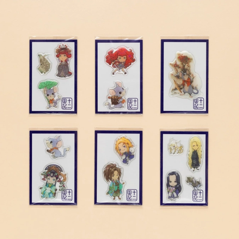 淡いベージュの背景に、6種類のキャラクターアクリルステッカーセットが並べられています。各セットには、アニメ調の人間キャラクターと動物キャラクター（主にネズミやウサギ）が含まれており、「十二記」という文字が書かれています。